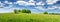 Green field panorama and blue sky with white clouds