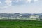 Green field in the shade and hill in the sun