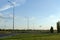 Green field view with lamp posts and flying little plane