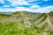 Green fields and mountains. Fascinating nature with unique mountains and rocks