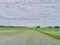 Green fields rice field with mudflats countryside with clouds and sky view