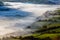 Green fields and rural farmland covered in low hanging mist and fog