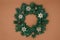 green fir thee Christmas wreath on beige background