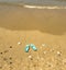 Green flip flops in Cuesta Maneli beach in the province of Huelva, Andalusia, Spain