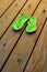 Green Flip Flops for Summer on Old Wood Deck