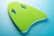 Green floating pad for kids to study swimming on blue