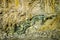 Green folded rock formation inside mountain wall