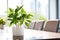 Green foliage plant in white flowerpot in office meeting room on a conference table. Concept of environmental, corporate