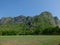 Green football field with a white goal  With a mountain background