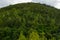 Green forest mountain at cloudy summertime. Nature landscape