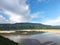 Green forest mountain and  heavy flowing river water with  white cloudy blue sky