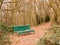 green forest public bench empty solitude tree arch autumn winter