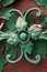 Green forged flower close-up. Fragment of decor of old doors as a background