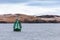 Green framed buoy with cone topmark