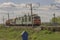 Green freight train transports cargo by rail