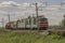 Green freight train transports cargo by rail