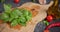 Green fresh Basil herb leaves on wooden cutting board