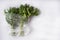 Green fresh drill and parsley in transparent plastic bag lie on white background.