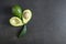 Green fresh ripe avocado whole and half fruits on black rustic background