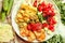 Green fresh salad with tomatoes, pink lentil mashed potatoes, baked potato slices with homemade ketchup.Vegetarian colorful lunch