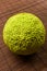 Green fruit of maclura pomifera, osage orange, horse apple, adam apple grow on bamboo mat