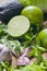 Green fruit and vegetable - wooden board with green food  ingredients: garlic, avocado, lime, mint, cilantro, leek, green chili