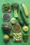 Green fruits and vegetables on a green background. Top down view. Closeup
