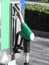 Green fuel pistol on gas station . Unleaded petrol at the pump station