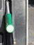 Green fuel pistol on gas station . Unleaded petrol at the pump station