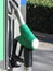 Green fuel pistol on gas station . Unleaded petrol at the pump station