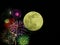 Green full moon with accent fireworks in nightsky