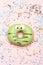 Green funny surprised donut on pink background