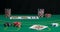 Green gambling table, with betting chips and cards with back black background