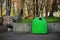 Green garbage containers outdoors on sunny day