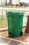 Green Garbage Trash Bin near Swimming Pool.