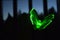 Green garden ornament luminous butterfly in a dark place during twilight