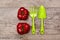 Green garden rake, shovel and ripe raw tomatoes on the flatlay wooden background