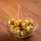 Green garlic stuffed olives in a glass bowl