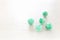 Green gemstones beads on white wooden background