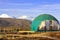 Green geo-dome tent on Kamchatka peninsula. Cozy, camping, glamping, holiday, vacation lifestyle concept. Outdoors cabin