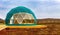 Green geodome tent. Cozy, camping, glamping, holiday, vacation lifestyle concept.
