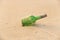 Green glass bottle with a message inside on the seashore on the beach. Magic and fairy tale. Design with copy space