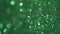 Green Glitter Background. Magic dust, shiny texture, holiday lights, flying particles form a beautiful bokeh. Shining