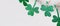Green glitter shamrocks homemade garland. Happy St. Patricks Day background, banner format