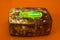 Green glowing tritium trinket on amber box