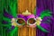 Green, gold, and purple Mardi Gras beads with mask