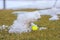 Green golf ball on cloudy snow covered golf course