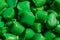 Green granules of polypropylene or polyamide. Macro photography. Plastics and polymers industry. Copy space.
