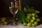 Green grapes with leaves, glass, bottle of white wine on vintage