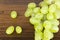 Green grapes on oak shelf